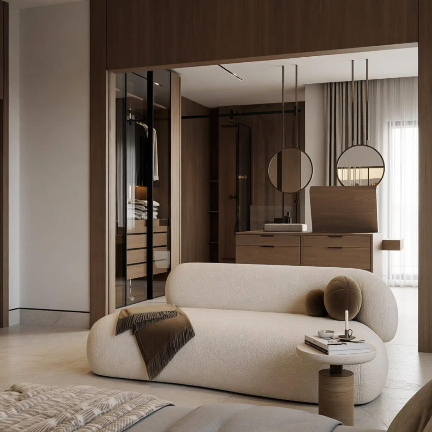 Dressing room with glass-fronted oak wardrobes and a curved boucle sofa