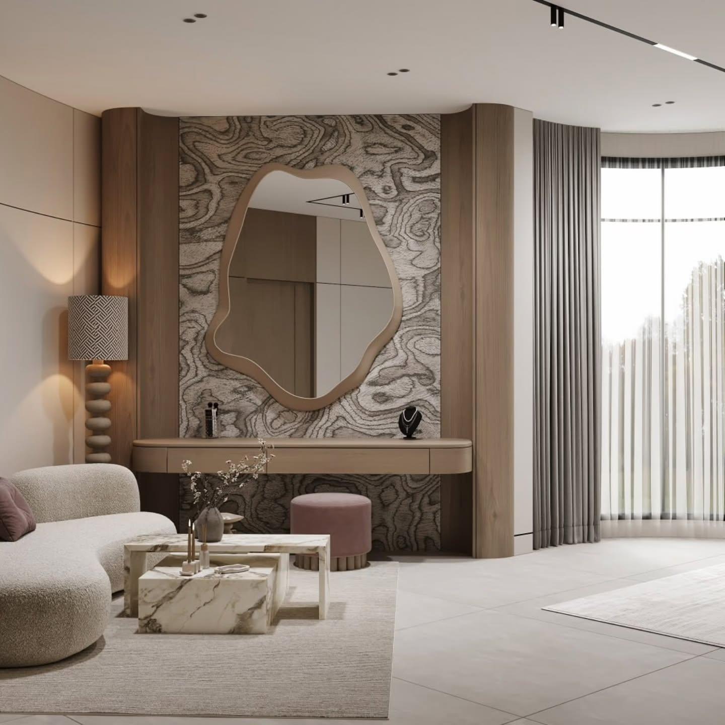 Vanity desk with a wavy-edged mirror on a patterned wall and a dusty-rose stool