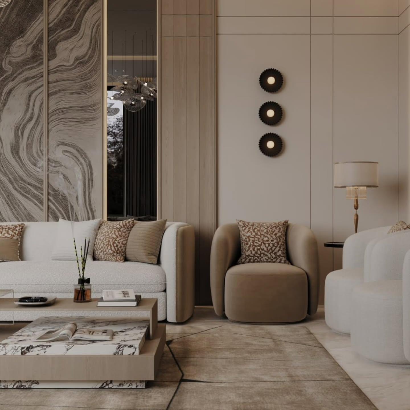 Living corner with a velvet armchair, sconce trio and a marble-topped table