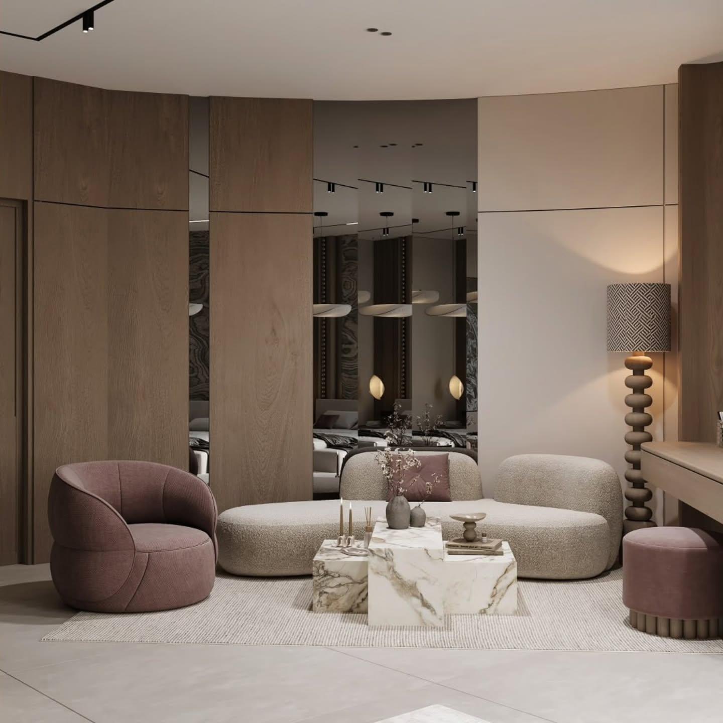 Seating area with a curved sofa, plum armchair and a tiered marble coffee table