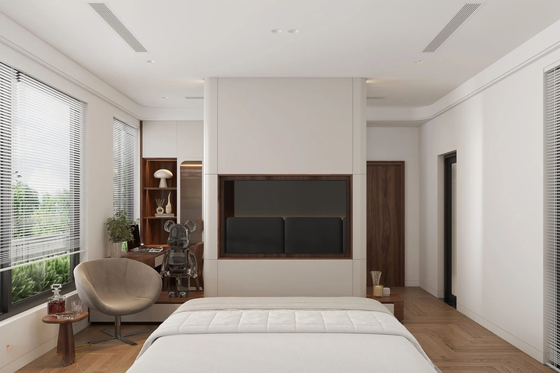 Bedroom seen from the foot of the bed past the TV partition and lounge chair