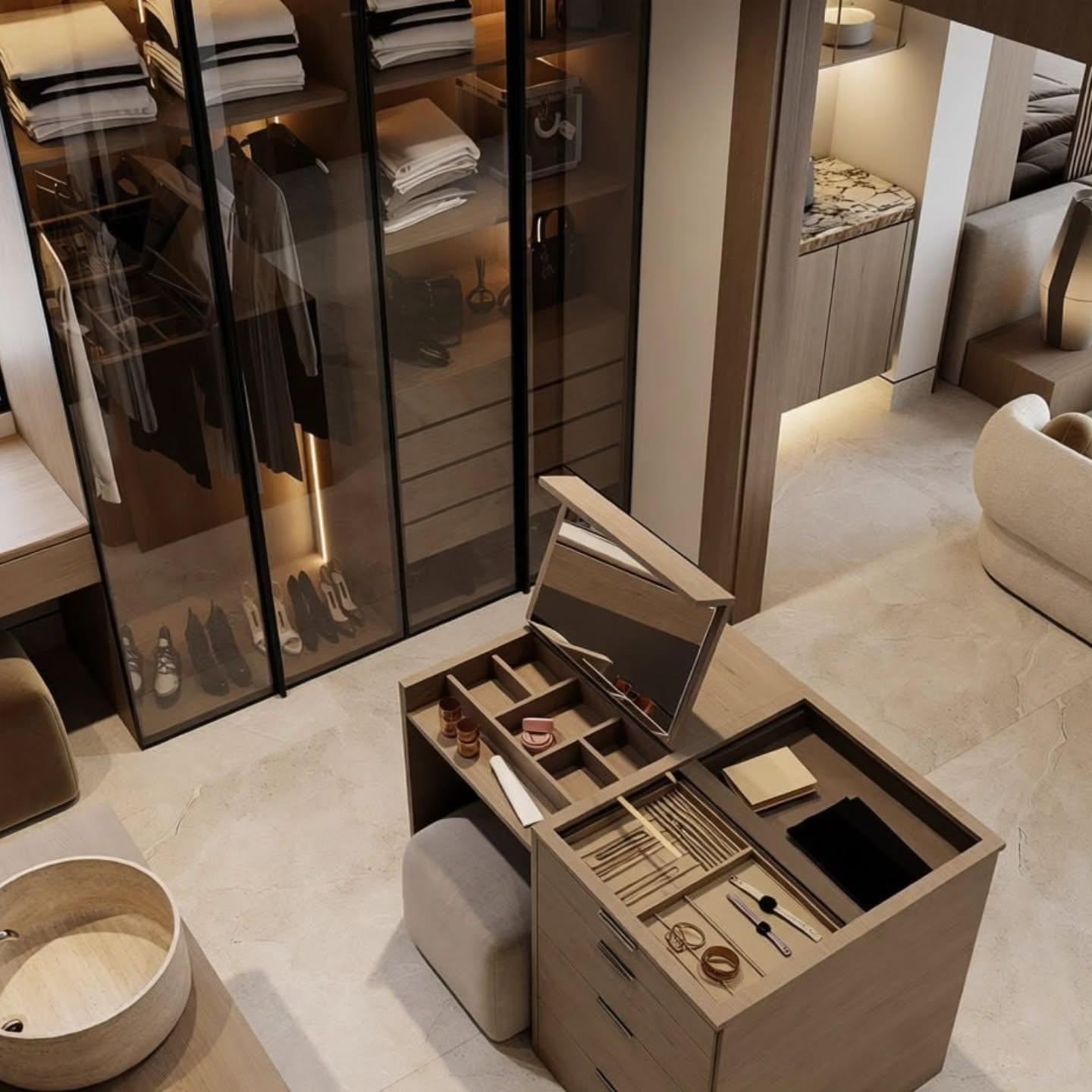 High-angle view across the dressing island to the glass wardrobes