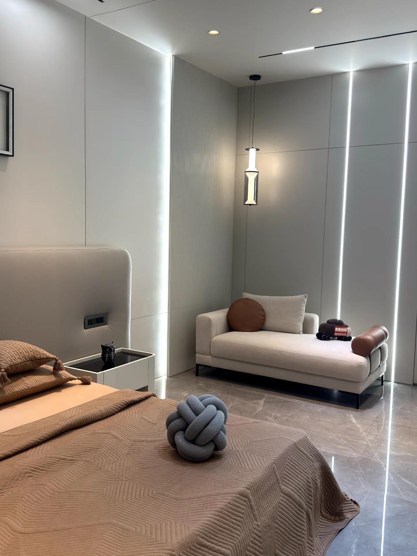 Bedroom corner with daybed against illuminated wall panelling