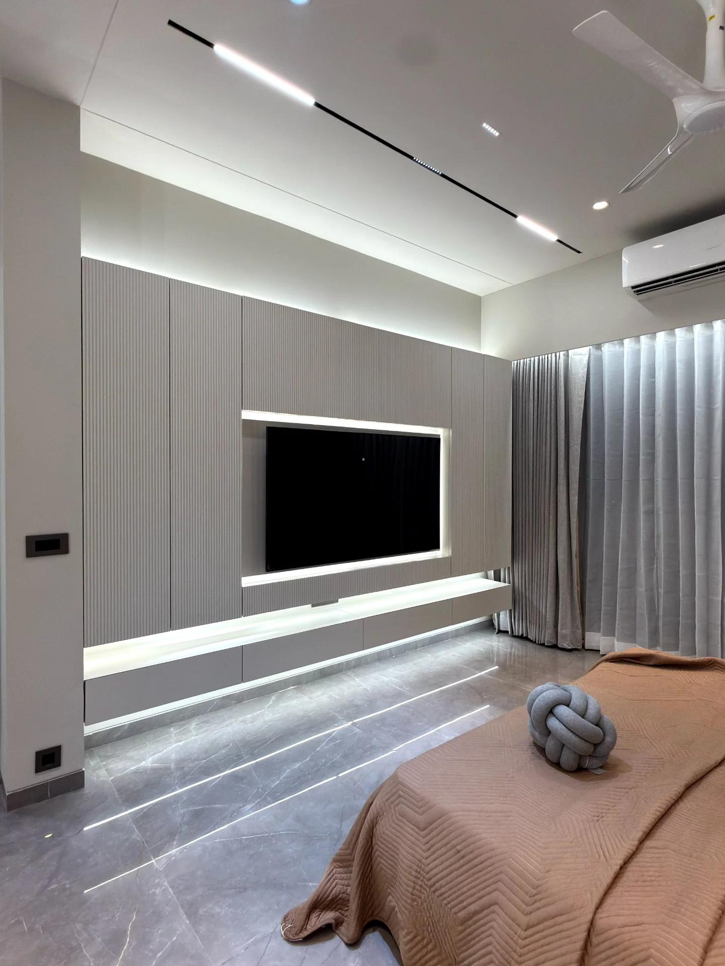 Bedroom media wall in fluted grey with cove-lit recess