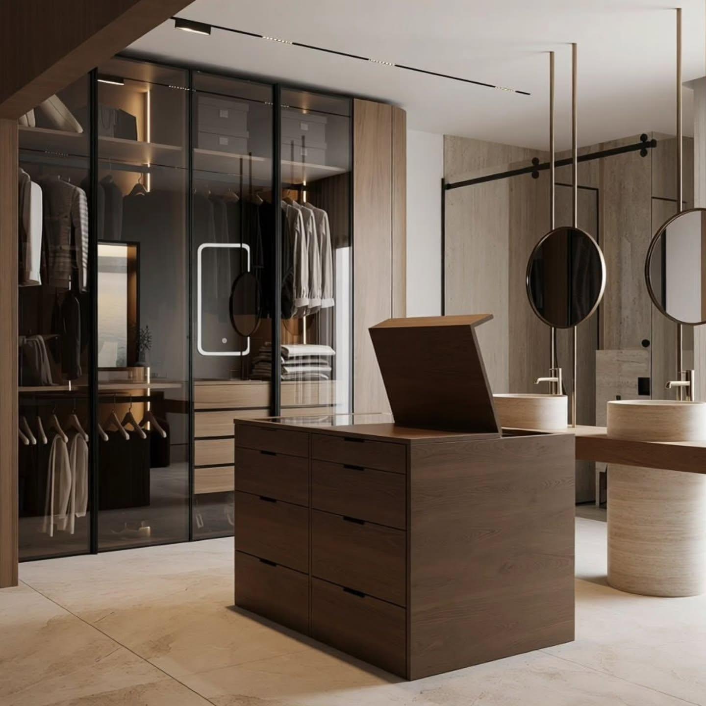 Wardrobe wall with internally lit glass doors and a stone-topped island dresser